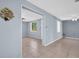 Bright living room with neutral paint, tile floors, ceiling fan and an open doorway at 1415 Yale Dr, Holiday, FL 34691