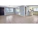 Bright and airy living space with tiled floors leading to an adjacent kitchen and front entrance at 1415 Yale Dr, Holiday, FL 34691