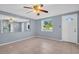 Welcoming living area with tile floors, a large window, and ample natural light, accented by a decorative ceiling fan at 1415 Yale Dr, Holiday, FL 34691