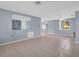 Spacious living room with tiled floors, neutral color palette, and ample natural light at 1415 Yale Dr, Holiday, FL 34691
