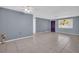 Living room with tile flooring, a ceiling fan and a view of the front entry at 1415 Yale Dr, Holiday, FL 34691