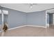 Neutral living room featuring a ceiling fan, base trim, and tile flooring at 1415 Yale Dr, Holiday, FL 34691