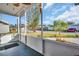 Enclosed porch featuring screens, offering an outdoor space with views of the neighborhood and surrounding landscape at 1415 Yale Dr, Holiday, FL 34691
