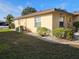 Charming home exterior featuring a well-maintained lawn and tidy landscaping under a clear blue sky at 1510 Flamingo Ln, Sun City Center, FL 33573