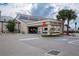 Fitness Center exterior with ample parking, palm trees, and easy access for a healthy lifestyle at 1510 Flamingo Ln, Sun City Center, FL 33573