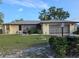 Well-kept home featuring a tidy lawn, landscaped bushes, and an enclosed garage at 1510 Flamingo Ln, Sun City Center, FL 33573