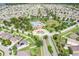 Wide aerial view showing an expansive planned community with mature trees, pool, and manicured landscaping at 15403 Wicked Strong St, Sun City Center, FL 33573