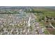 Extensive aerial view showcases a neighborhood with ponds and green spaces at 15403 Wicked Strong St, Sun City Center, FL 33573
