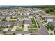 Wide aerial view showcasing the neighborhood with neatly arranged houses and landscaping at 15403 Wicked Strong St, Sun City Center, FL 33573