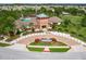 Beautiful aerial view of community entrance, clubhouse, and landscaped grounds at 15403 Wicked Strong St, Sun City Center, FL 33573