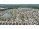 Aerial view of a community featuring neatly arranged homes, green spaces and a view of nearby ponds and nature at 15403 Wicked Strong St, Sun City Center, FL 33573