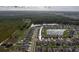 Aerial shot of homes near a large pond and nature area showcasing a well-planned residential neighborhood at 15403 Wicked Strong St, Sun City Center, FL 33573