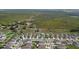 Extensive aerial view showcases a neighborhood with ponds, green spaces and homes with coordinated design elements at 15403 Wicked Strong St, Sun City Center, FL 33573