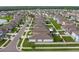 Expansive aerial view of a residential community with well-maintained lawns and numerous single-Gathering homes at 15403 Wicked Strong St, Sun City Center, FL 33573