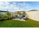 Outdoor living space with seating in a fenced backyard is great for entertaining at 15403 Wicked Strong St, Sun City Center, FL 33573