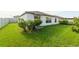 Spacious backyard with a well-manicured lawn and privacy bushes at 15403 Wicked Strong St, Sun City Center, FL 33573