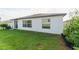 Well-maintained backyard featuring lush green grass and a lovely garden at 15403 Wicked Strong St, Sun City Center, FL 33573