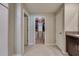 Well-organized bathroom hallway with closet access and tile flooring, offering practical storage and convenience at 15403 Wicked Strong St, Sun City Center, FL 33573