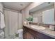 Functional bathroom with dark wood vanity, granite countertop, shower, and toilet, providing essential amenities at 15403 Wicked Strong St, Sun City Center, FL 33573