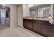 Double sink bathroom vanity and closet access, designed with granite counters and efficient storage at 15403 Wicked Strong St, Sun City Center, FL 33573