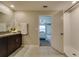 Bright bathroom with shower, vanity, and view to main bedroom makes getting ready easy at 15403 Wicked Strong St, Sun City Center, FL 33573