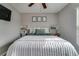 Neutral bedroom with a plush bed, ceiling fan, and decorative accents, offering a cozy and stylish retreat at 15403 Wicked Strong St, Sun City Center, FL 33573