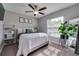 Bright bedroom features a ceiling fan, large window, and neutral décor, creating a serene and inviting atmosphere at 15403 Wicked Strong St, Sun City Center, FL 33573