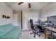 A bedroom with a large desk and plenty of lighting, perfect for gaming and streaming at 15403 Wicked Strong St, Sun City Center, FL 33573