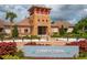 Welcoming community clubhouse entrance with brick details and well-maintained landscaping at 15403 Wicked Strong St, Sun City Center, FL 33573