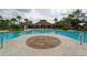 Beautiful community pool with inviting turquoise water, surrounding palm trees, and convenient lounge area at 15403 Wicked Strong St, Sun City Center, FL 33573