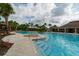 Large community pool with splash pad, seating, and ample decking at 15403 Wicked Strong St, Sun City Center, FL 33573