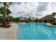 Expansive community pool with ample seating, landscaping, and a pavilion at 15403 Wicked Strong St, Sun City Center, FL 33573