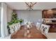 Elegant dining area with natural light, modern light fixture, and statement wall paneling at 15403 Wicked Strong St, Sun City Center, FL 33573