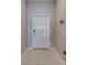 Clean entryway featuring tile flooring, a white front door, and neutral wall colors at 15403 Wicked Strong St, Sun City Center, FL 33573