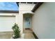 Close-up of the front door with a decorative wreath and a covered entryway for added appeal at 15403 Wicked Strong St, Sun City Center, FL 33573