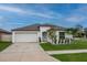 Charming single-story home with a well-manicured lawn, a two-car garage, and lovely curb appeal at 15403 Wicked Strong St, Sun City Center, FL 33573