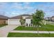 Well-maintained single-Gathering home with a lush green lawn and a neatly paved driveway at 15403 Wicked Strong St, Sun City Center, FL 33573