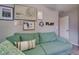 Cozy living room features a comfortable green sofa and stylish wall art, creating a welcoming atmosphere at 15403 Wicked Strong St, Sun City Center, FL 33573