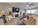 Bright living room showcasing a stylish fireplace, neutral color palette, and comfortable sectional sofa at 15403 Wicked Strong St, Sun City Center, FL 33573