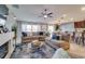 Bright open-concept living room featuring a fireplace, bar seating and a sectional sofa at 15403 Wicked Strong St, Sun City Center, FL 33573