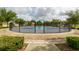 Community pickleball court with a modern design, surrounded by lush landscaping at 15403 Wicked Strong St, Sun City Center, FL 33573
