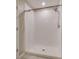 White tiled shower with updated shower head is crisp and clean at 15403 Wicked Strong St, Sun City Center, FL 33573