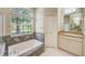 Bathroom with a soaking tub, decorative tile, and a large window view at 1610 Stetson Dr, Wesley Chapel, FL 33543