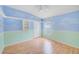 Bedroom with Custom Wall Paint, laminated wood floors and ceiling fan at 1610 Stetson Dr, Wesley Chapel, FL 33543