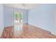Bright bedroom featuring wood floors and sliding glass doors leading to an enclosed patio at 1610 Stetson Dr, Wesley Chapel, FL 33543