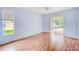 Light-filled bedroom with wood floors and sliding glass doors to the outdoor patio at 1610 Stetson Dr, Wesley Chapel, FL 33543