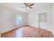 Bright bedroom featuring a built-in bookshelf and laminated wood floors at 1610 Stetson Dr, Wesley Chapel, FL 33543