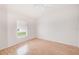 Bright bedroom featuring a laminated wood floors and window at 1610 Stetson Dr, Wesley Chapel, FL 33543