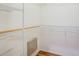 Walk-in closet with metal shelving and wood floors at 1610 Stetson Dr, Wesley Chapel, FL 33543