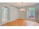 Dining area with hardwood floors, stylish chandelier, and a large window at 1610 Stetson Dr, Wesley Chapel, FL 33543